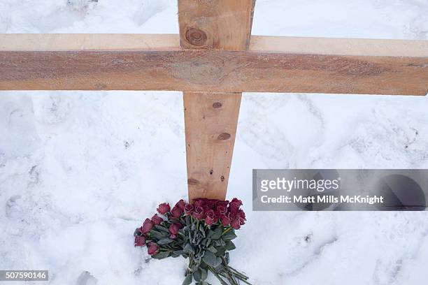 Cross has been erected and roses placed at its base along the side of Highway 395 where LaVoy Finicum was shot and killed by federal agents January...