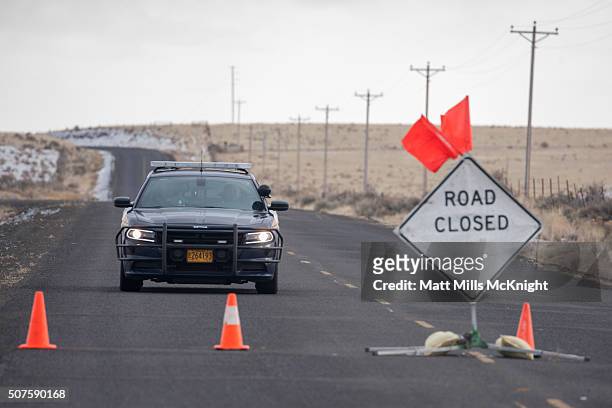 An Oregon State Trooper approaches a road block along the Malheur National Wildlife Refuge January 30, 2016 in Burns, Oregon. Eight protestors who...