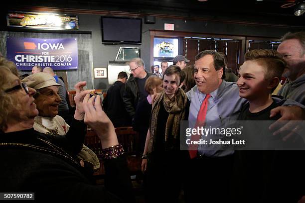 New Jersey Governor and Republican presidential candidate Chris Christie poses for a picture as he greets people during a campaign event at the...