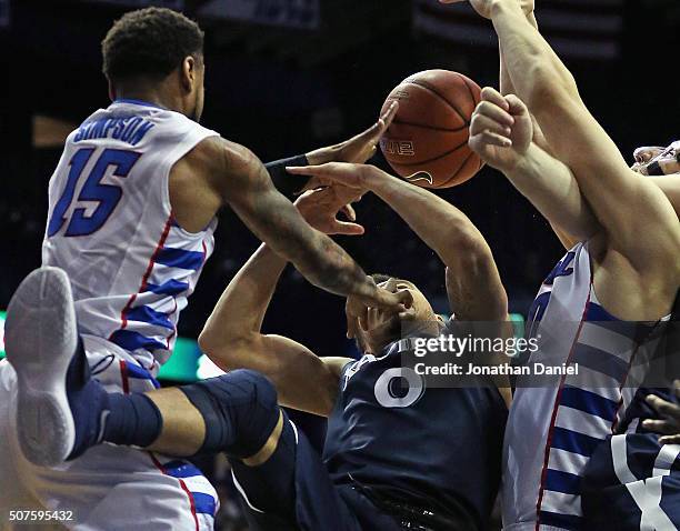 Larry Austin Jr. #0 of the Xavier Musketeers takes a hand tothe face while trying to rebound from Aaron Simpson of the DePaul Blue Demons at Allstate...