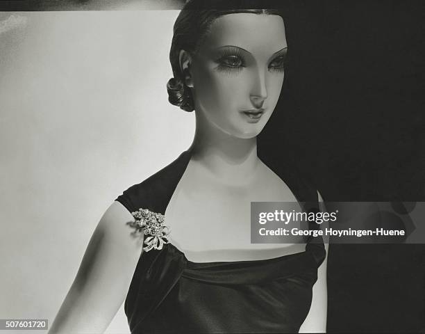 Mannequin wearing grape-cluster brooch with diamonds embedded in bas-relief by Van Cleef and Arpels.
