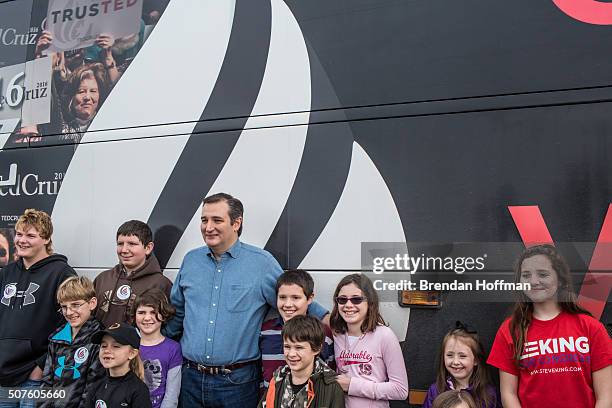 Republican presidential candidate Sen. Ted Cruz poses for a picture with children following a campaign event at Darrell's Place on January 30, 2016...