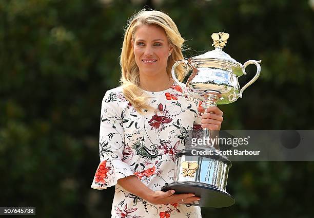 Angelique Kerber of Germany holds the Daphne Akhurst Memorial Cup during a photocall at Government House after winning the 2016 Australian Open on...
