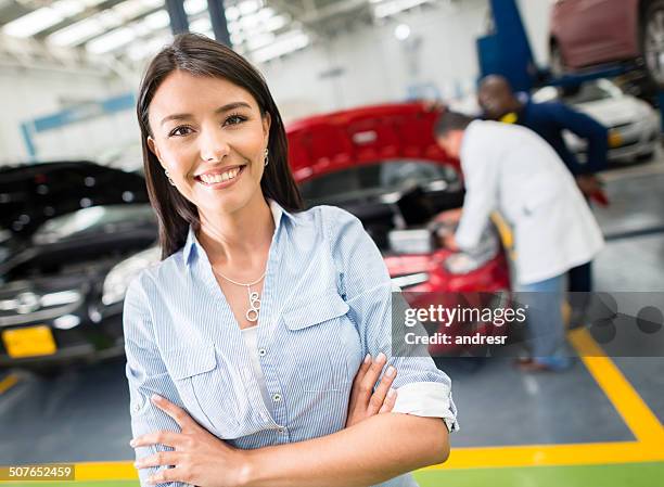 woman taking car to the mechanic - happy client by broken car stock pictures, royalty-free photos & images