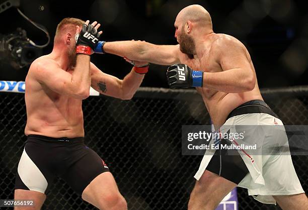 Ben Rothwell punches Josh Barnett in their heavyweight bout during the UFC Fight Night event at the Prudential Center on January 30, 2016 in Newark,...