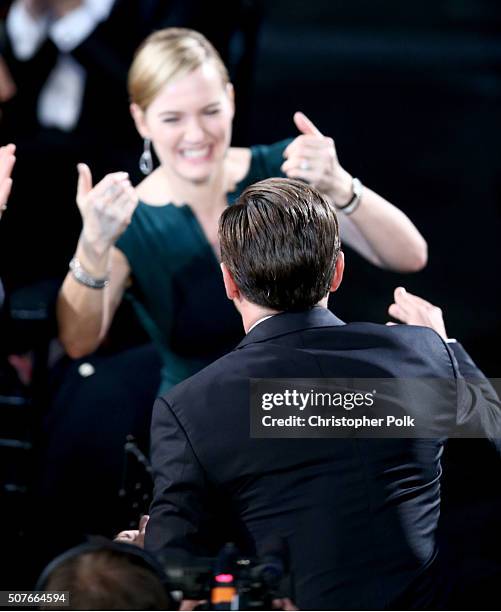 Actress Kate Winslet congratulates actor Leonardo DiCaprio after he wins the award for Outstanding Performance by a Male Actor in a Leading Role for...