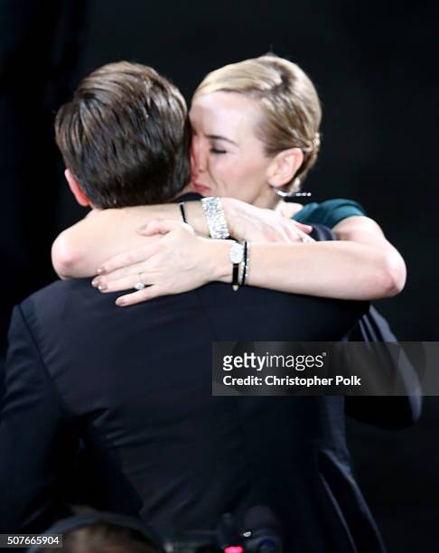 Actress Kate Winslet congratulates actor Leonardo DiCaprio after he wins the award for Outstanding Performance by a Male Actor in a Leading Role for...