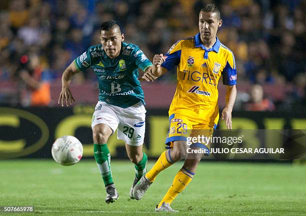 Jesus Dueñas of Tigres vies for the ball with Aldo Rocha of León during the Mexican Clausura 2016 tournament football match at the Universitario...