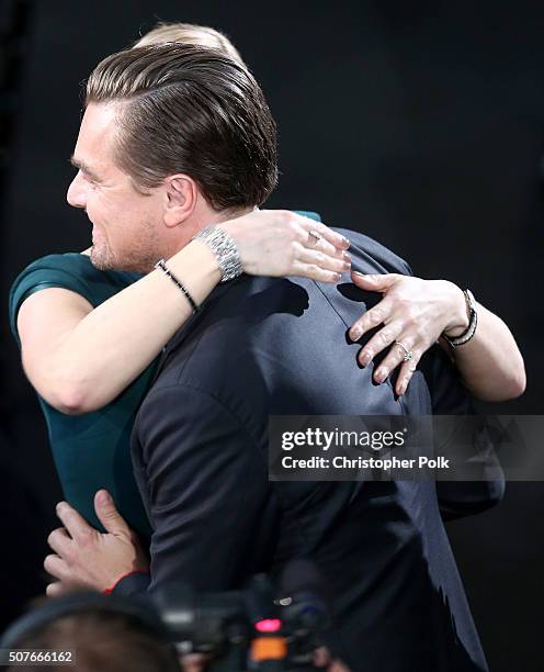 Actress Kate Winslet congratulates actor Leonardo DiCaprio after he wins the award for Outstanding Performance by a Male Actor in a Leading Role for...