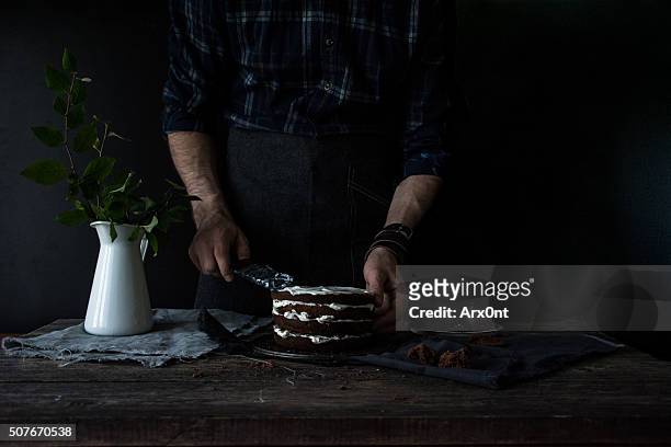 Decorating chocolate cake with vanilla cream