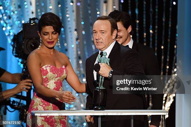 Actor Kevin Spacey accepts the Male Actor in a Drama Series award for 'House of Cards' from actors Priyanka Chopra and Pedro Pascal onstage during...