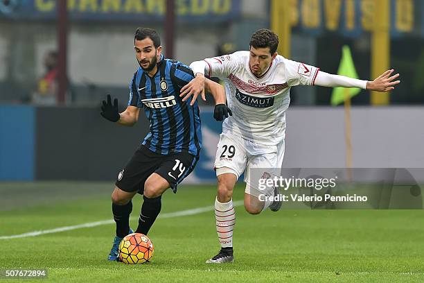Martin Montoya of FC Internazionale Milano is challenged by Raphael Martinho of Carpi FC during the Serie A match between FC Internazionale Milano...