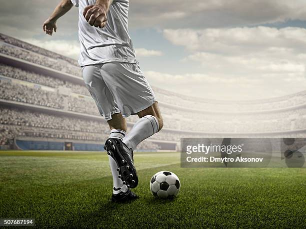 soccer player kicking ball in stadium - shootout stock pictures, royalty-free photos & images