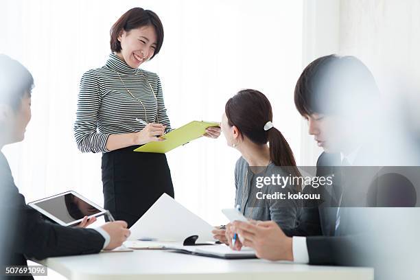 business people to a meeting while looking at the document - japan training session stock pictures, royalty-free photos & images