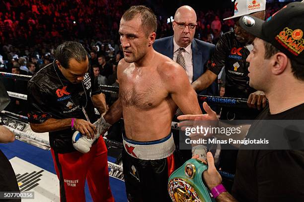 Sergey Kovalev of Russia prepares to get his gloves taken off by his team after defeating Jean Pascal of Canada by way of TKO at the end of the...