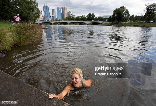 In this handout photo provided by Tennis Australia, Angelique Kerber of Germany jumps into the Yarra River on day 14 of the 2016 Australian Open at...