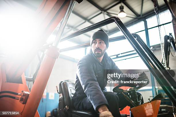 man driving a forklift - forklift stock pictures, royalty-free photos & images