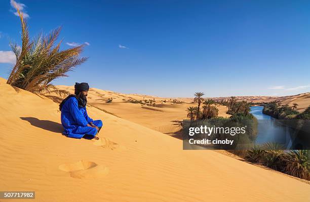 tuareg on dune , um el ma , mandara lake , sahara, libya - mandara lakes stock pictures, royalty-free photos & images