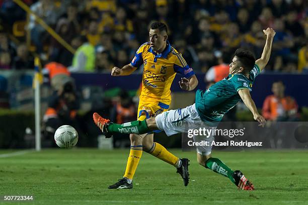 Israel Jimenez of Tigres fights for the ball with Efrain Velarde of Leon during the fourth round match between Tigres and Leon as part of the...