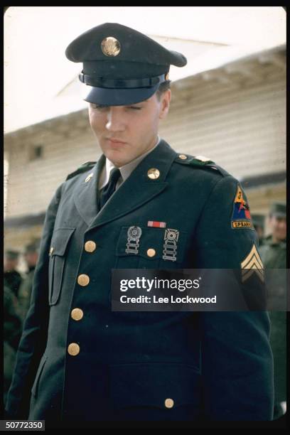 Elvis Presley outside in uniform on his last day serving in US Army.