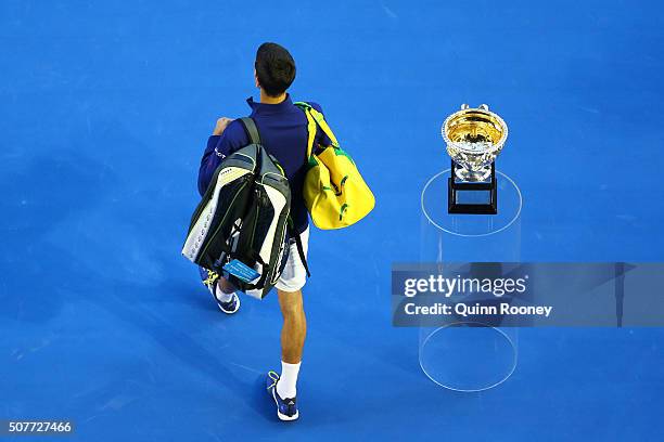 Novak Djokovic of Serbia walks past the Norman Brookes Challenge Cup ahead of his Men's Singles Final match against Andy Murray of Great Britain...