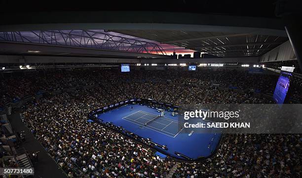 Sun sets over the skyline as Britain's Andy Murray plays during his men's singles final match against Serbia's Novak Djokovic on day fourteen of the...