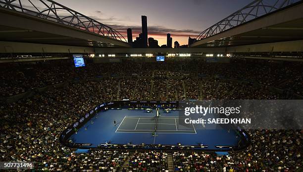 Sun sets over the skyline as Britain's Andy Murray plays during his men's singles final match against Serbia's Novak Djokovic on day fourteen of the...