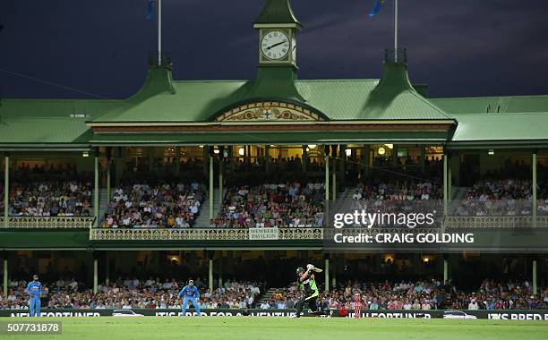 Shane Watson of Australia hits a boundary during the third Twenty20 international cricket match between India and Australia in Sydney on January 31,...