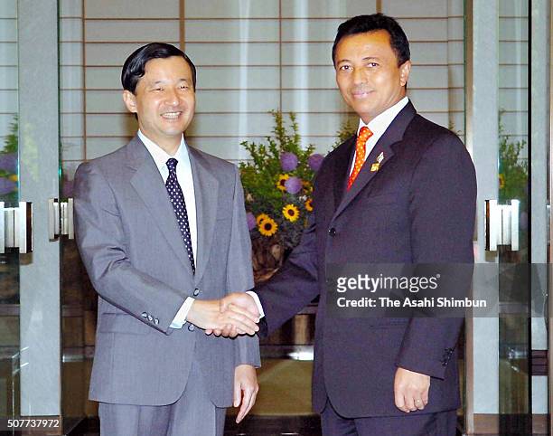 Madagascar President Marc Ravalomanana shakes hands with Crown Prince Naruhito at the Akasaka Palace on June 1, 2005 in Tokyo, Japan.