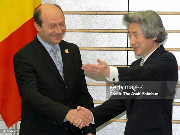 Romanian President Traian Basescu and Japanese Prime Minister Junichiro Koizumi shake hands prior to their meeting at Koizumi's offcial residence on...