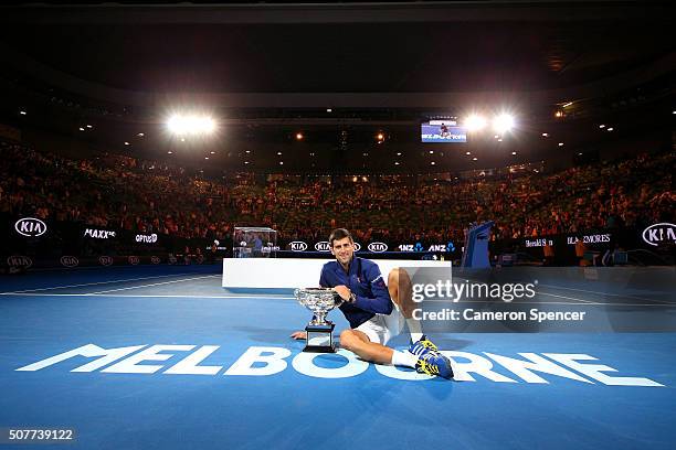 Novak Djokovic of Serbia holds the Norman Brookes Challenge Cup after winning the Men's Singles Final over Andy Murray of Great Britain during day 14...