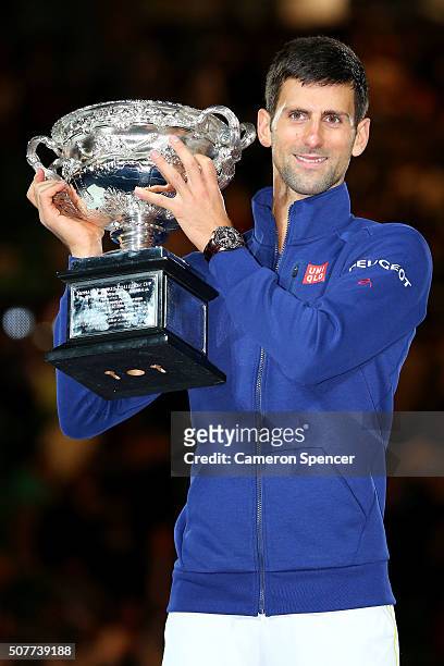 Novak Djokovic of Serbia holds the Norman Brookes Challenge Cup after winning the Men's Singles Final over Andy Murray of Great Britain during day 14...