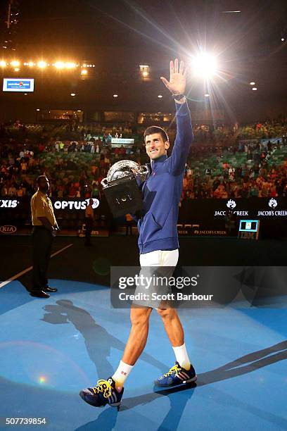 Novak Djokovic of Serbia holds the Norman Brookes Challenge Cup after winning the Men's Singles Final over Andy Murray of Great Britain during day 14...