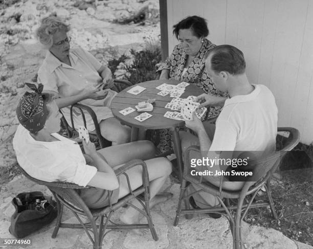 Jean Howard , Mrs. Richard Fellowes-Gordon , Elsa Maxwell and Jimmy Donahue playing cards.