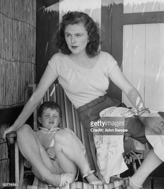 Divorced wife of Randolph Churchill, Pamela, in slacks, with small son Winston Churchill II, at Eden Roc.
