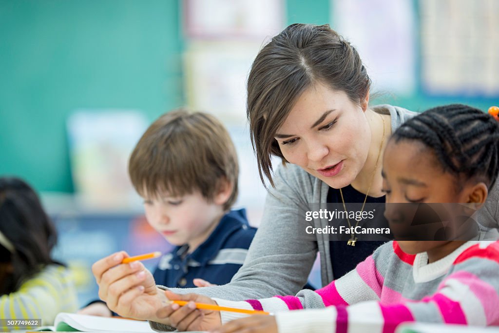 Teacher Helping a Student Understand an Assignment