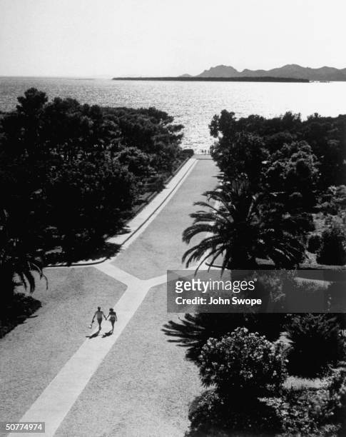 From Hotel du Cap d' Antibes, looking down promenade leading to Pavilion Eden Roc and the sea.
