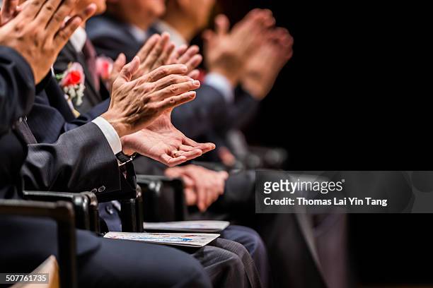 shareholders clapping hands on positive report - accionista fotografías e imágenes de stock