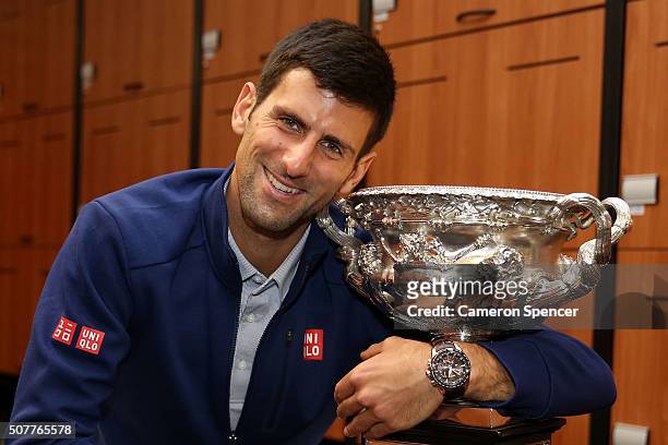 Novak Djokovic of Serbia poses with the Norman Brookes Challenge Cup in the players change rooms after winning the Men's Singles Final against Andy...