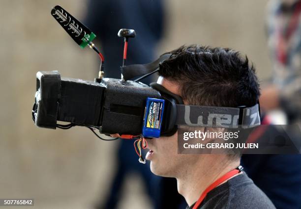 Man wearing virtual reality glasses, pilots a drone during the Global Robot Expo in Madrid on January 31, 2016. The Global Robot Expo fair brings...