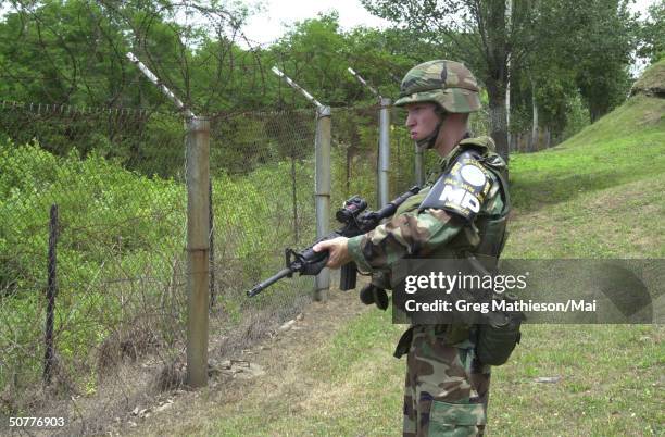 United States Army soldier standing guard by facing border of North Korea in Demilitarized Zone as part of United Nations Security Force established...