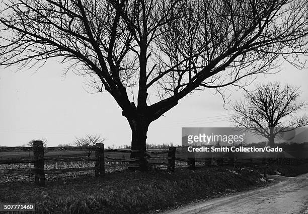 Farmland and country roads in winter, surrounded by a handmade wooden fence installed by the state, Bethlehem, Pennsylvania, 1936. From the New York...