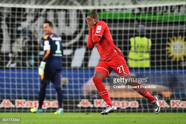 Diego Benaglio of VfL Wolfsburg looks dejected as Anthony Modeste of Cologne celebrates as he scores their first and equalising goal during the...