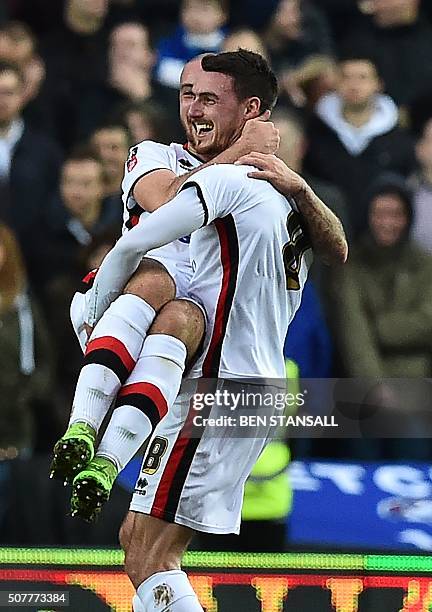 Dons' Irish midfielder Darren Potter celebrates with MK Dons' English midfielder Samir Carruthers after scoring their first goal during the English...