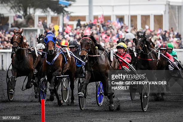 French jockey Franck Nivard riding Bold Eagle leads the race during the 95th Prix d'Amerique equestrian trotting world championship at the...