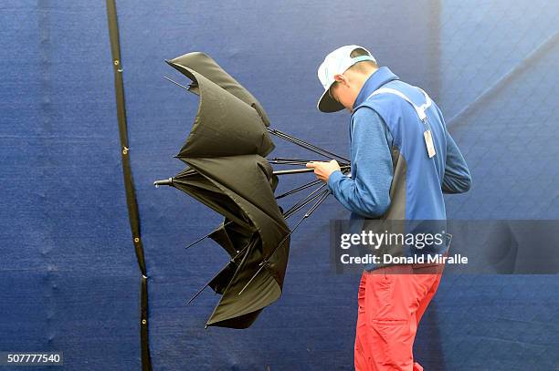 Spectator walks off the course as wind and rain delay play during the final round of the Farmers Insurance Open at Torrey Pines South on January 31,...