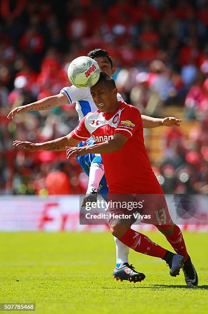 Christian Bermudez of Puebla struggles for the ball with Christian Cueva of Toluca during the fourth round match between Toluca and Puebla as part of...