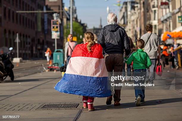 grandfather taking kids to kingsday 2014 - dutch flag stock pictures, royalty-free photos & images