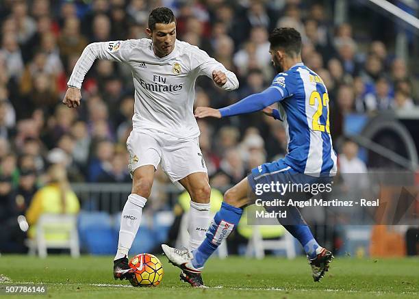 Cristiano Ronaldo of Real Madrid competes for the ball with Alvaro Gonzalez of Espanyol during the La Liga match between Real Madrid CF and Real CD...