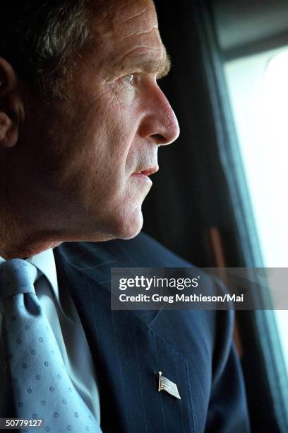 President George W. Bush looking out the window while touring the World Trade Center disaster site aboard Marine One.